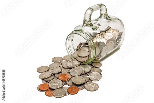 Photo: Glass Mug With Coins Spilling Out XXXL Isolated Glass Mug With Coins Spilling Out XXXL Isolated