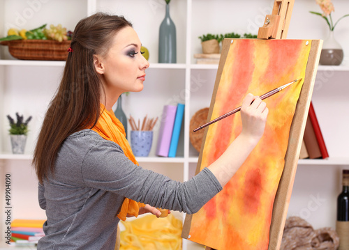 Photo: beautiful young woman painter at work, beautiful young woman painter at work,