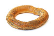 Bagel covered with poppy seeds on a white background.