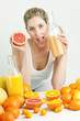 portrait of young woman with citrus fruit and orange juice