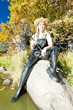 Foto: fisher woman with landing net sitting on stone fisher woman with landing net sitting on stone