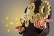 businessman hand show golden gear to success as industry concept