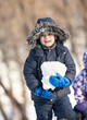 Cute boy playing with snow