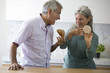 Mature couple eating snack food