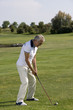 Mature man playing golf