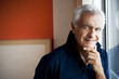Mature man standing at window