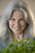Mature woman holding basel plant