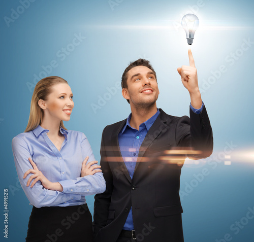 Photo: man and woman with light bulb man and woman with light bulb