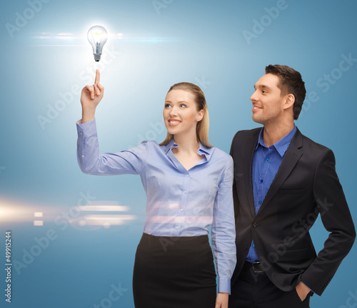 Photo: man and woman with light bulb man and woman with light bulb