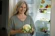 Mature woman holding cauliflower
