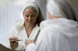Mature woman looking in mirror