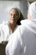 Mature woman looking in mirror