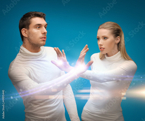 Photo: man and woman working with magic man and woman working with magic