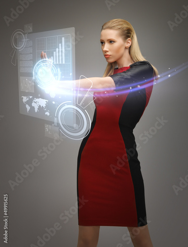 Photo: woman working with virtual touchscreens woman working with virtual touchscreens