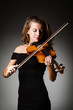 Woman performer with violin in studio