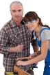 Carpenter and young female employee