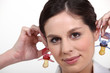 Woman holding baby soothers near her ears