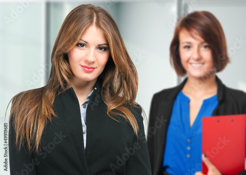 Photo: Couple of young businesswomen Couple of young businesswomen