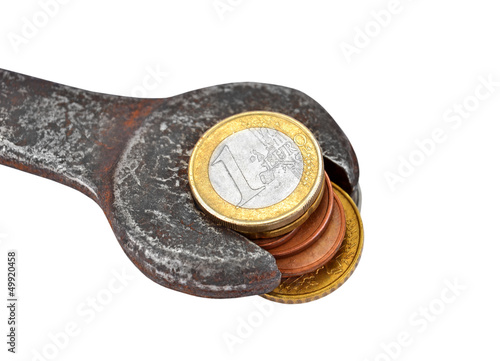 Photo: Making money, earning for job, Euro coin and rusty wrench Making money, earning for job, Euro coin and rusty wrench