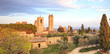 San Gimignano landmark medieval town on sunset, towers and park.