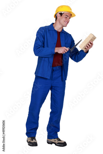 Photo: Mason holding brick and trowel Mason holding brick and trowel