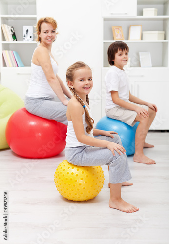 Photo: Happy family exercising at home Happy family exercising at home