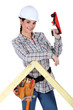 Woman using wood plane