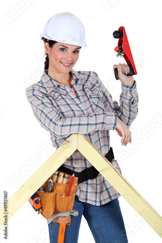 Photo: Woman using wood plane Woman using wood plane
