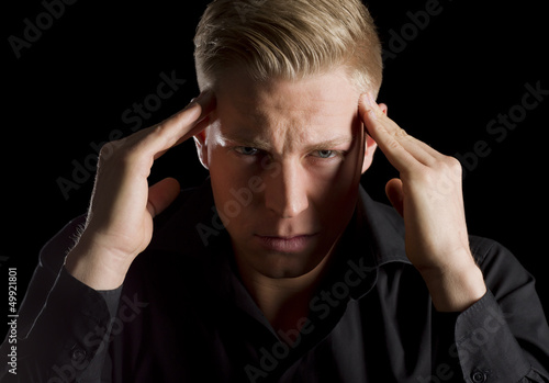 Photo: Low key portrait of unhappy young man. Low key portrait of unhappy young man.