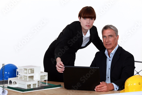 Photo: Architect and assistant working on housing project Architect and assistant working on housing project