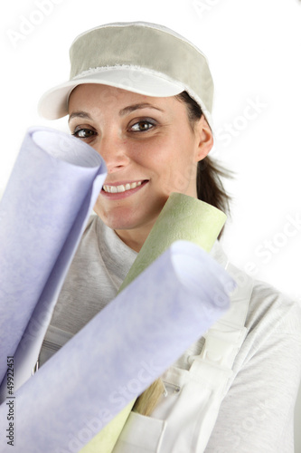 Photo: Woman holding selection of wallpaper Woman holding selection of wallpaper