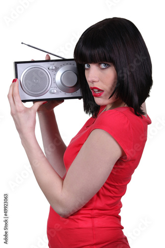 Photo: Lady in red listening to a radio Lady in red listening to a radio