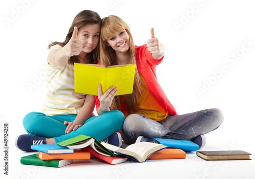 Photo: Two Teenage Girls reading The Book.Education Two Teenage Girls reading The Book.Education