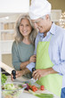 Mature couple preparing food