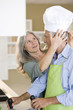 Mature couple preparing food