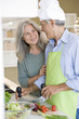 Mature couple preparing food