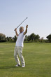 Mature man playing golf