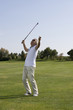 Mature man playing golf