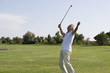 Mature man playing golf