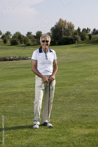 Photo: Mature man playing golf Mature man playing golf