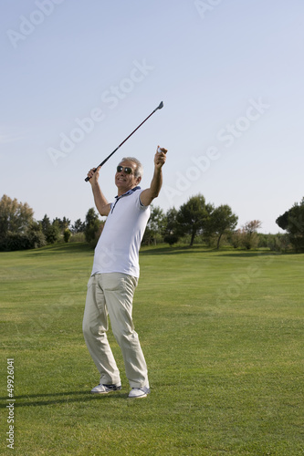 Photo: Mature man playing golf Mature man playing golf