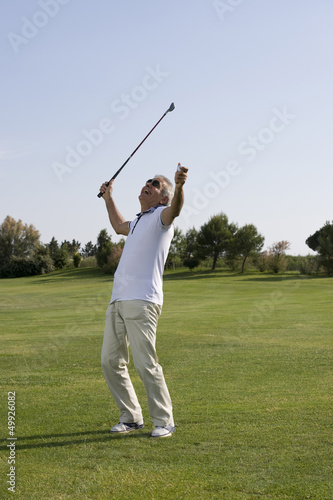 Photo: Mature man playing golf Mature man playing golf