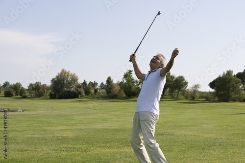 Photo: Mature man playing golf Mature man playing golf