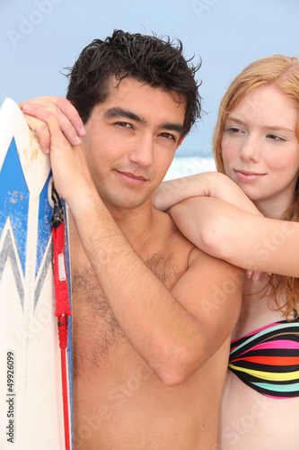 Photo: Young man and redhead with surfboard Young man and redhead with surfboard