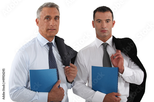 Photo: Two businessmen stood with folders Two businessmen stood with folders