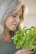 Mature woman holding basel plant