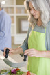 Mature woman preparing food