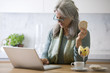 Photo: Mature woman with laptop computer Mature woman with laptop computer
