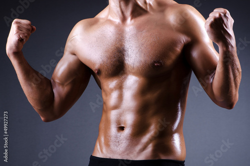 Photo: Muscular man in dark studio Muscular man in dark studio
