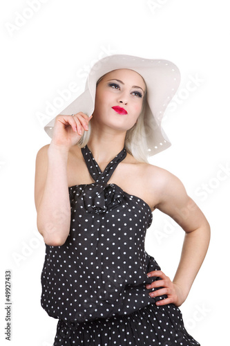 Photo: Attractive woman in hat and dotted dress, isolated on white Attractive woman in hat and dotted dress, isolated on white